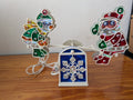 Santa & Angel Seesaw Light from Unknown (Possibly H.C. Company or a similar brand) - 1980s-1990s Holiday Decor (Plastic, Holographic Foil, Wiring Christmas Light Decoration, Christmas, Holiday, Retro, Kitsch, White, Red, Green, Blue, Yellow)